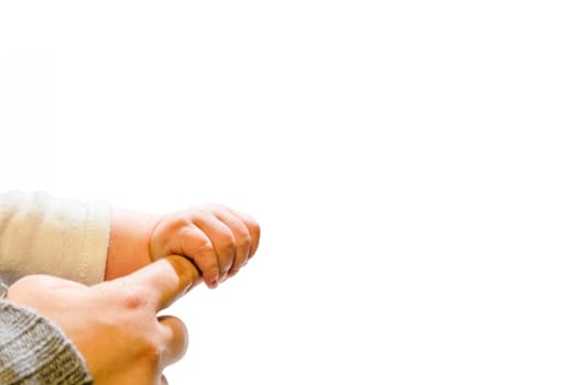 Baby with mom's finger. Small hand reaches for big hand.