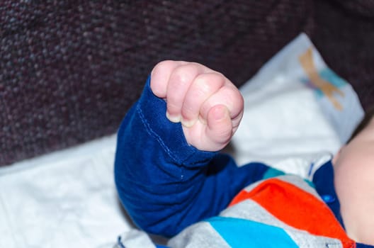 Close-up,baby hand clenched to fist.