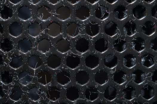 Dusty ventilation grid with round holes macro