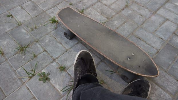 Old used skateboard lies on the ground