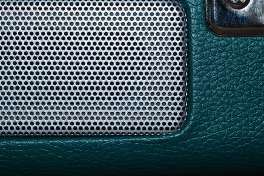 Grid of speaker with round holes. gray protective mesh