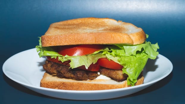 Big tasty sandwich with ham, salami, salad, cheese and tomatoes on white background