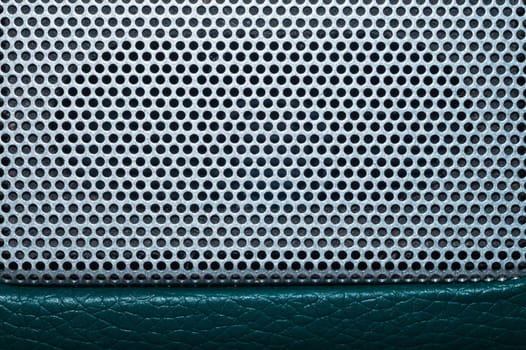 Grid of speaker with round holes. gray protective mesh