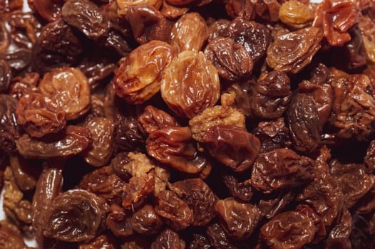 Dried raisins on a white background. Raw grapes and raisins. Healthy and fresh nuts. close-up. Local name besni uzum