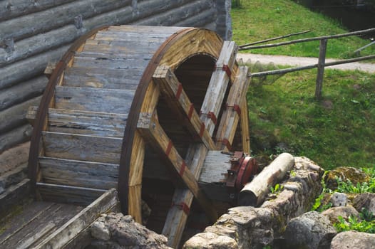 Old wooden wheel from a water mill. rural landscape