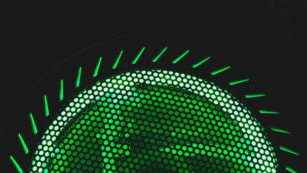 Detail of computer fan with green light abstract background. cooler grid close up. rgb led illumination