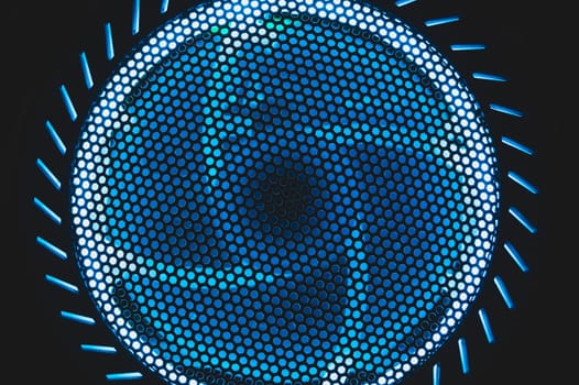 PC cooler fan with blue led lights illumination in the dark. abstract futuristic background