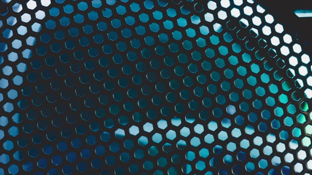 Detail of computer fan with blue color light abstract background. cooler grid close up. rgb led illumination