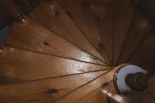 Spiral wooden stairway in country house. homemade interior