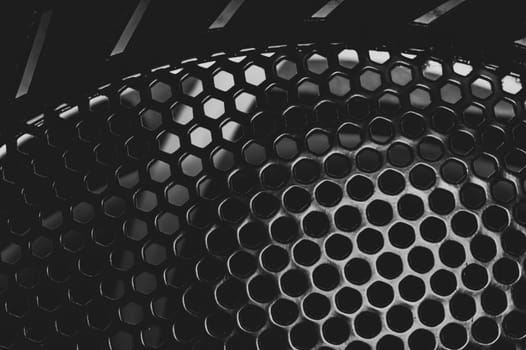 Grid with round holes abstract background. protective mesh of computer cooling system close up