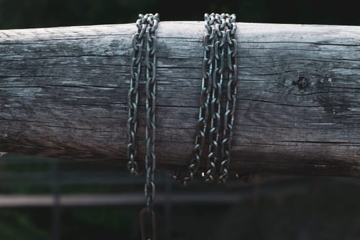 Detail of wooden winch with chain. part of mechanism of water from the well