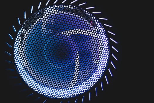 PC cooler fan with blue led lights illumination glows in the dark. abstract futuristic background