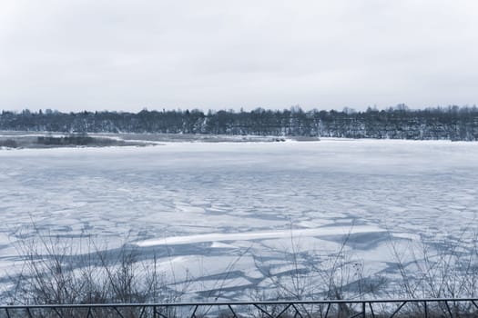 Frozen river with cracked ice. cold weather