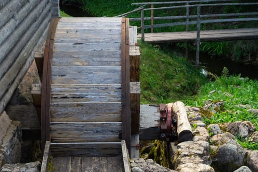 Old wooden wheel from a water mill. rural landscape