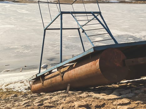 Small pontoon boat with iron construction on the paved shore