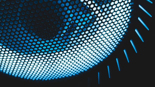 Detail of computer fan with blue color light abstract background. cooler grid close up. rgb led illumination