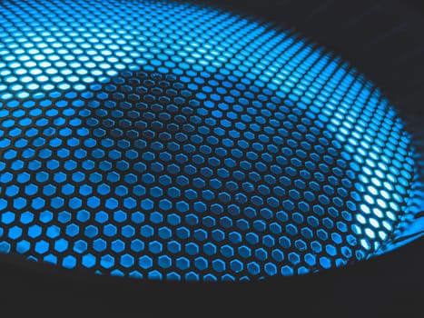 Detail of computer fan with blue color light abstract background. cooler grid close up. rgb led illumination