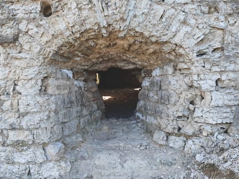 Ancient window hole in old stone wall of medieval tower