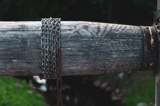 Detail of wooden winch with chain. part of mechanism of water from the well