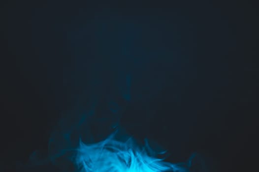 Blue smoke clouds in the dark abstract background. fog floating in air