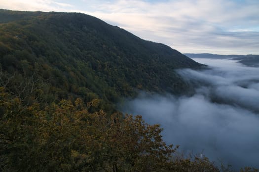 Fog rising on the mountains of the small Saar loop. mystical silence on the river Saar in Saarland.
