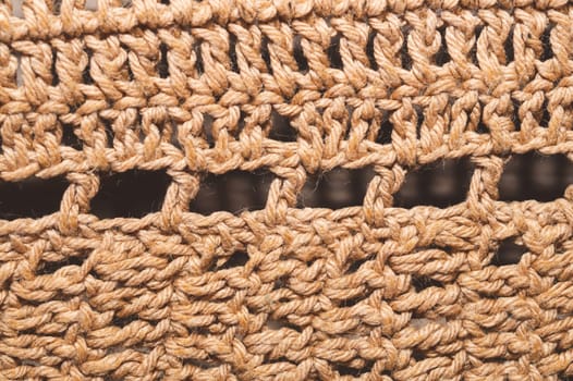 Knitted background from jute threads. weaving texture. woven backdrop close up