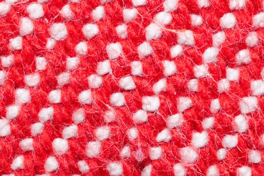 Handmade knitted fabric. red and white woolen background