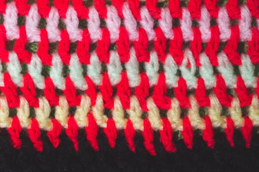 Knitted background from colored threads close up. homemade needlework