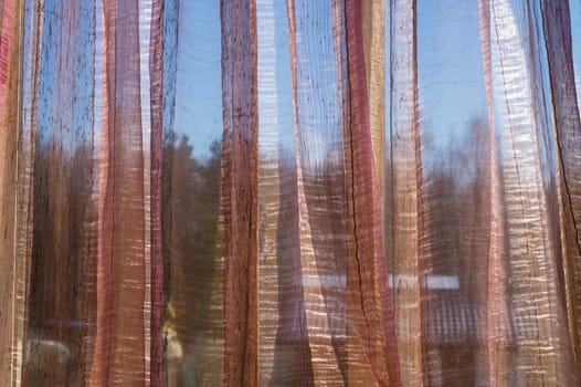 Sunlight shines through transparent curtain. morning light