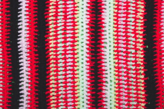 Knitted background from colored threads close up