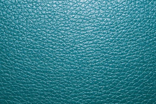Blue colored leather surface background close up