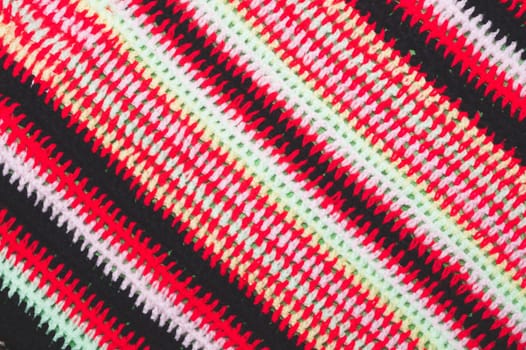 Knitted background from colored threads close up