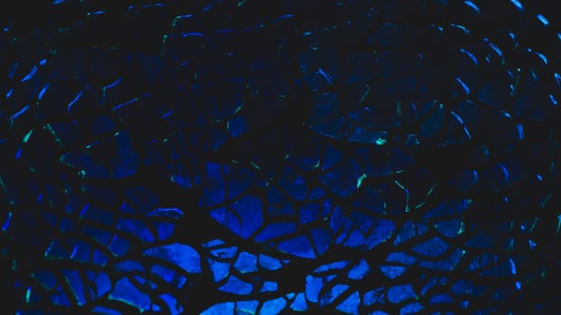 Shattered transparent glass pattern in the dark. abstract cracked background. blue splinters