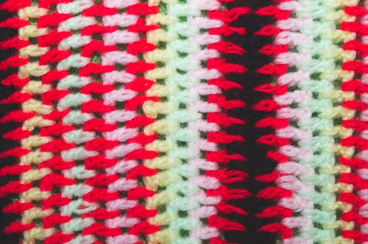 Knitted background from colored threads close up. homemade needlework