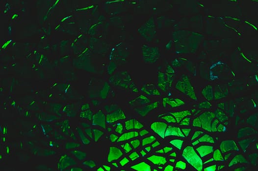Shattered transparent glass pattern in the dark. abstract cracked background