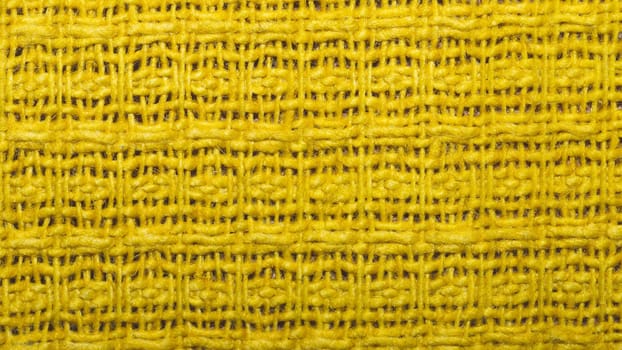 Yellow weave fabric background with waffle pattern close up