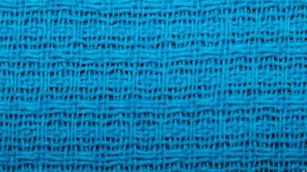 Blue fabric background with waffle pattern close up