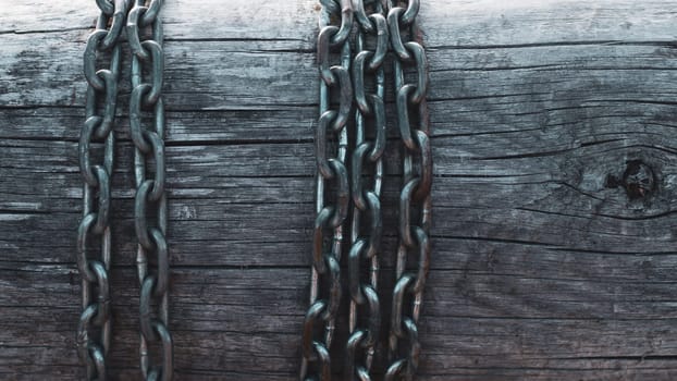 Metal chain on wooden wall background
