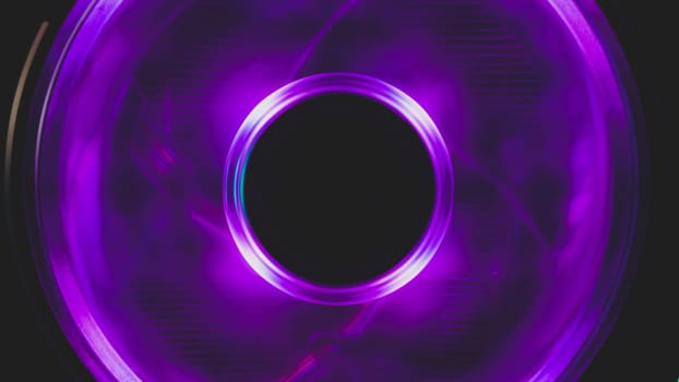 Violet light of computer cooling fan close up. cooler in action with leds. abstract background. power in motion concept