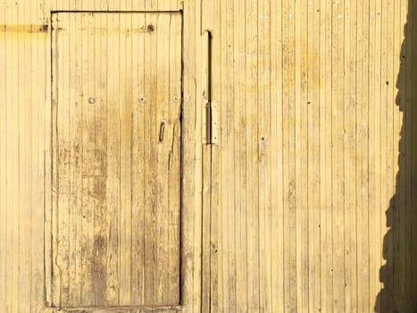 Wooden plank door in wooden wall. barn entrance