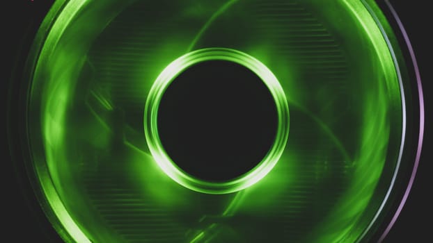 Computer cooling fan with green light close up. cooler in action with leds. power in motion concept. abstract background