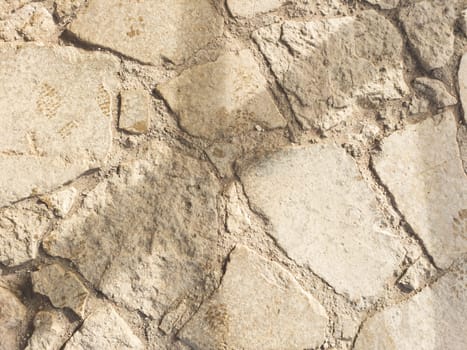 Ancient pavement stone background close up. old cobblestone backdrop