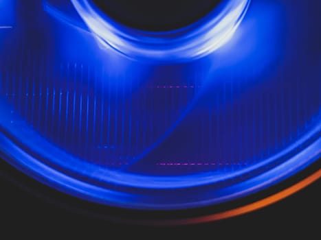 Computer cooling fan with blue light abstract background. cooler in action with led close up. power in motion concept