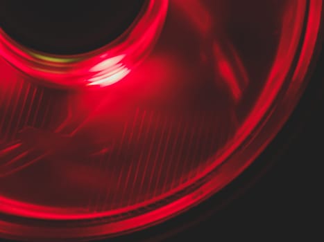 Red light of computer fan close up. cooler in action with leds. abstract background. power in motion concept