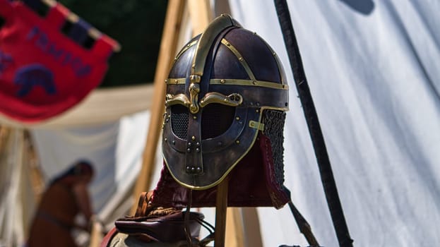 Medieval equipment, helmet, metal glove, armor. In the medieval spectacle you dive into past times. Show, jugglers and entertainment.
