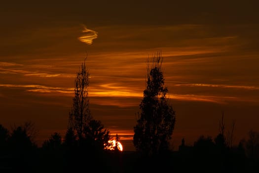 Setting sun on the outskirts of Berlin. The sky seems to burn. Romantic evening sky.