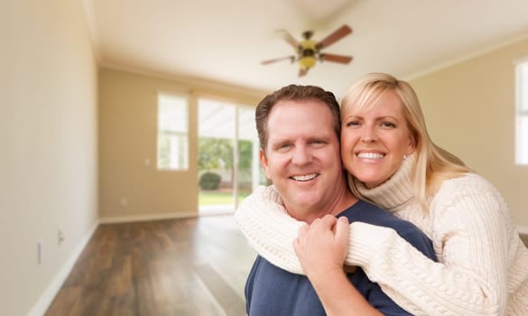 Happy Caucasian Young Adult Couple In Empty Room of House.