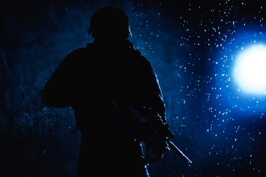 Special forces fighter, counter terrorist team shooter aiming assault rifle, shooting in firefight, breaking through rain on battlefield, rushing on enemies, attacking targets on moon night lit by moonlight