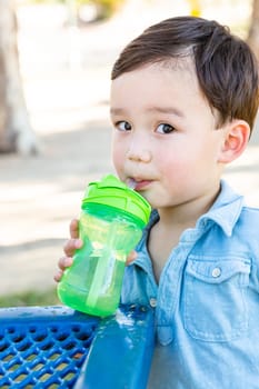 Chinese and Caucasian Boy Drinking Water At Playground.