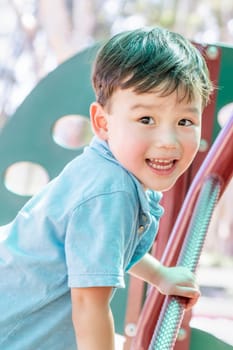 Chinese and Caucasian Boy Having Fun At The Playground.